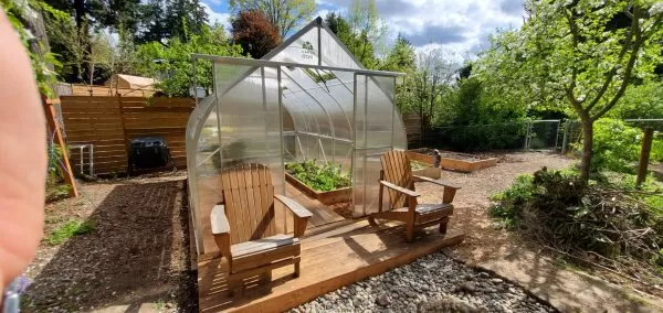 ClimaPod 9x14 Greenhouse Kit customer photo with wooden chairs